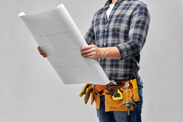 male builder with blueprint and working tools - Fotoğraf, Görsel