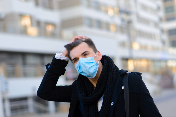 People with face mask. Concept with copy space. Portrait of adult man in quarantine of flu. Photo on the streets in the city - Фото, зображення