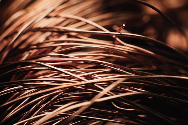Copper scrap metal, wire, windings of motors and transformers, electrical wire without insulation. Against the background of a copper sheet. Close-up. Macro. - Photo, Image