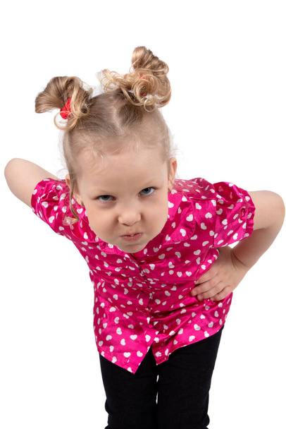 The little girl puffed out her cheeks. Funny child blonde in bright clothes. The girl is outraged. Five year old baby - Foto, imagen