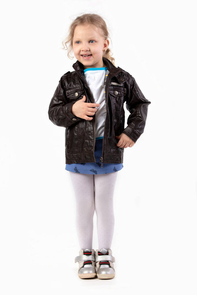 Little blonde girl in full growth on a white background. Five year old child. - Foto, imagen