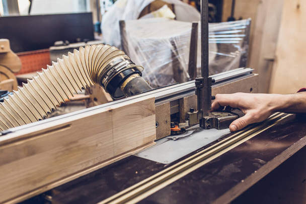 Carpenter workshop - master adjusts milling machine - Fotoğraf, Görsel