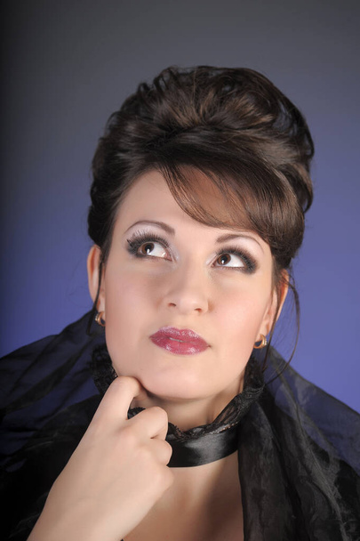 beautiful brunette woman in black sexy clothes with a large neckline portrait - Fotografie, Obrázek