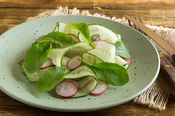 spring vitamin salad with fresh vegetables on a wooden table. - Φωτογραφία, εικόνα