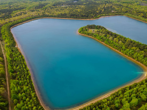 Beautiful panorama aerial view of blue lakes on a green forests in sunny summer day - Photo, Image