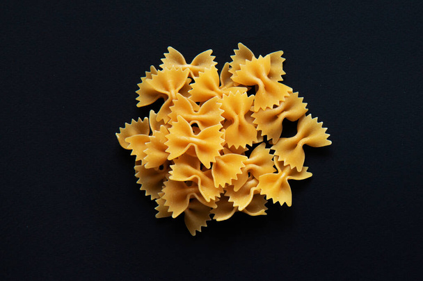 Farfalle pasta isolated on black background - Foto, Imagem