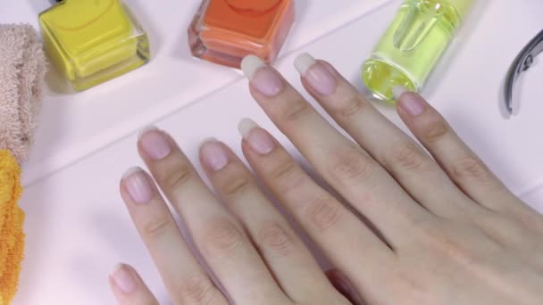 Manicure. Women's hands with short and long nails. Natural long nails, unpainted. Compare and choose the length of your nails. Clean, beautiful, French manicure. Home nail care, SPA, beauty, salon. - Footage, Video