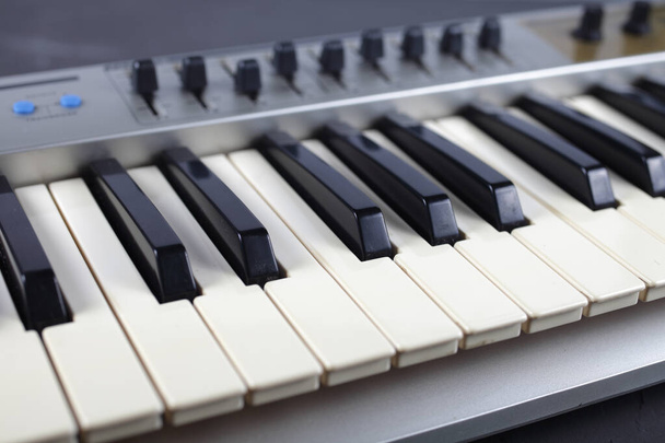 muzikale midi keyboard staat op een tafel - Foto, afbeelding