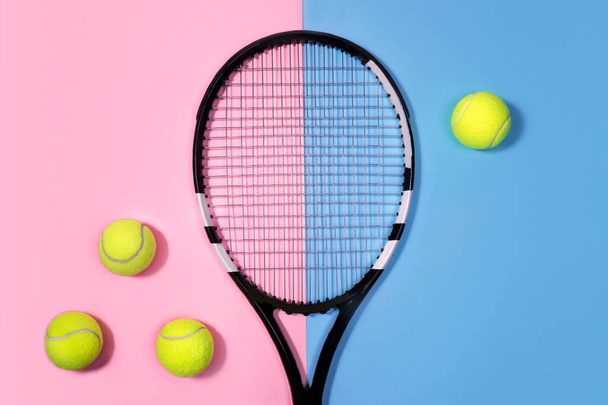 Tennis concept with balls and tennis racket on pastel pink and blue background.  - Fotografie, Obrázek