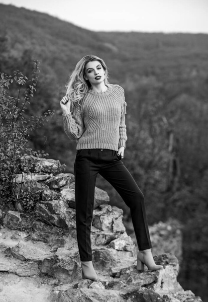 In the middle of nowhere. feeling romantic in fall. sexy woman red lipstick nature. warm and cosy seasonal clothes. girl long hair. autumn color trends. pretty fashion model in knitted sweater - Zdjęcie, obraz