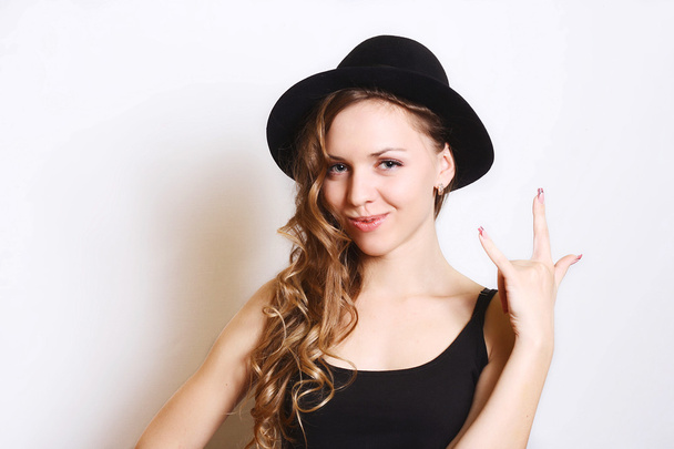Beautiful young woman in black hat.white background. - Φωτογραφία, εικόνα