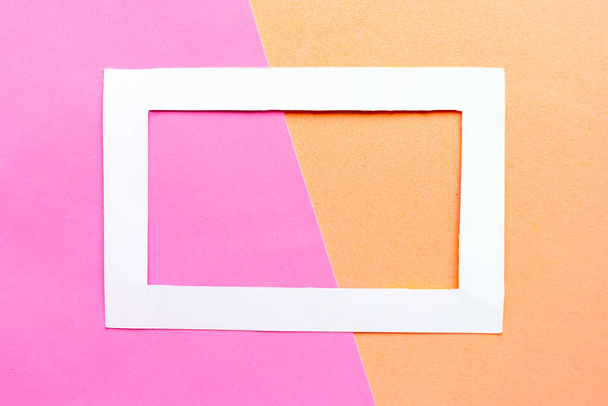 White photo frame on geometric color pastel background. Copy space for the text. Design concept - Foto, afbeelding