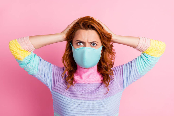 Closeup photo of stupor pretty lady keep social distance look staring arms on head read banner quarantine bad information wear protect face mask sweater isolated pink color background - Fotografie, Obrázek