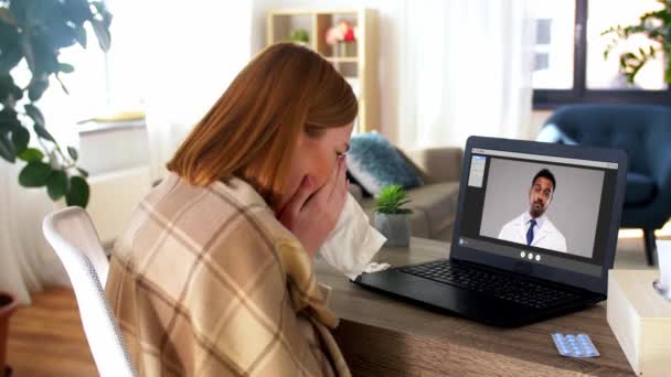 sick woman having video call with doctor at home - Záběry, video