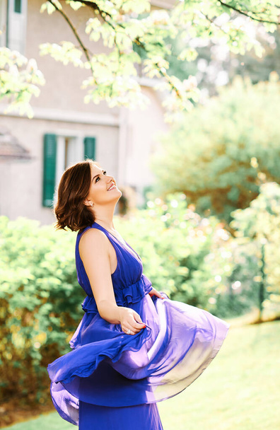 Summer portrait of beautiful charming woman with short haircut wearing purple dress - Foto, imagen