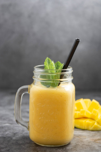 Summer mango and pineapple smoothie. Fresh fruit yellow smoothie drink. - 写真・画像