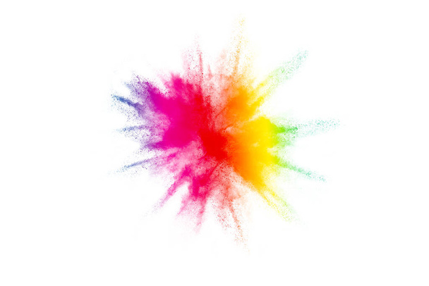 Παγωμένη κίνηση πολύχρωμης σκόνης χρώματος που εκρήγνυται σε λευκό φόντο.  - Φωτογραφία, εικόνα