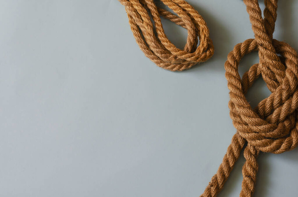 Marine subjects, boating, travel and vacation background. Natural ropes on a light blue background. A variety of twisted hemp ropes. View from above. Copy space - Photo, Image