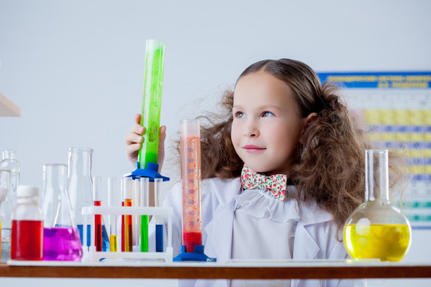 Image of cute girl posing with colorful flasks - Zdjęcie, obraz