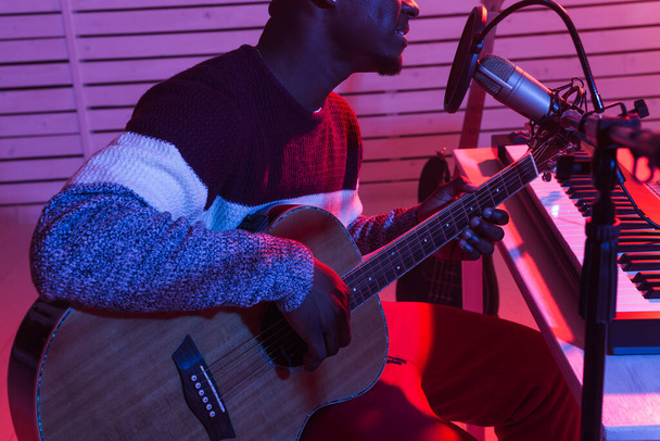 Muzikant en het maken van muziek concept - Afrikaans-Amerikaanse mannelijke geluidsproducent werkt in opnamestudio, close-up. - Foto, afbeelding
