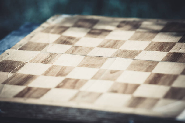 Black and white squares on a wooden chessboard for the game - Fotoğraf, Görsel