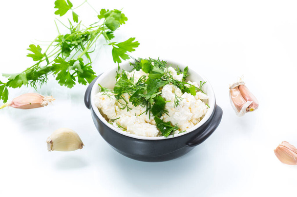 salted homemade cottage cheese with garlic and herbs in a bowl isolated on white background - Fotoğraf, Görsel