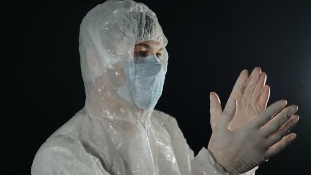 doctor in protective antiviral suit and mask applauds, fight against coronavirus pandemic covid-19 - Footage, Video