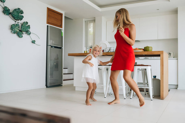 Happy mother and daughter having dancing at home. - Photo, image