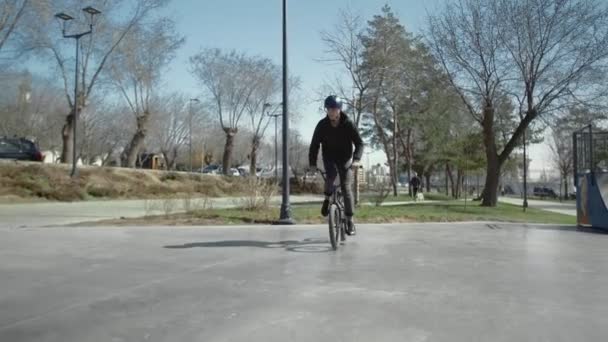 Nuori BMX ratsastaja tekee temppuja putkella skate park
. - Materiaali, video