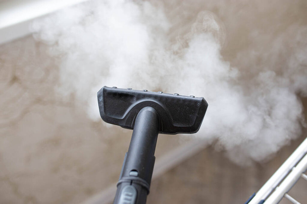 steam erupting from brush of steam cleaner for cleaning house - Φωτογραφία, εικόνα