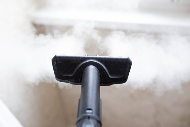 steam erupting from brush of steam cleaner for cleaning house - Фото, зображення