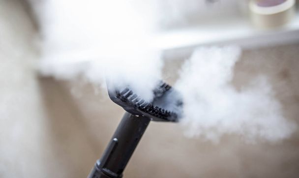 steam erupting from brush of steam cleaner for cleaning house - Foto, Imagem