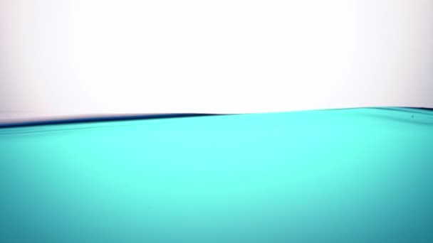 Een zuiver blauwe golf van water, in een halfrustige staat, een symbool van zuiverheid, frisheid en ecologie. Close-up. - Video
