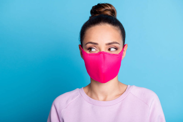 Portrait photo of pretty lady keep social distance citizen look side empty space see handsome guy sympathizing flirting wear protect bright face mask sweater isolated blue color background - Foto, imagen