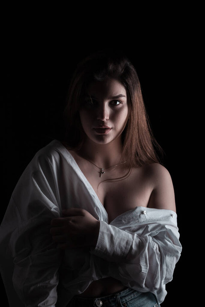 Beautiful model posing over black background. Portrait - Foto, Imagem