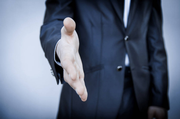 Businessman stretching his hand for a handshake - Foto, immagini
