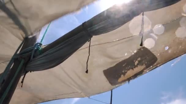 Dilapidated Sails Floating Against Blue Midday Sky with Particular Clouds - Footage, Video
