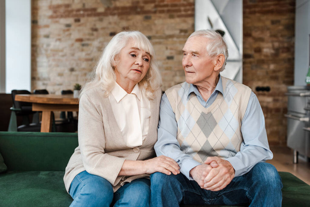 upset senior couple sitting at home on self isolation - Φωτογραφία, εικόνα