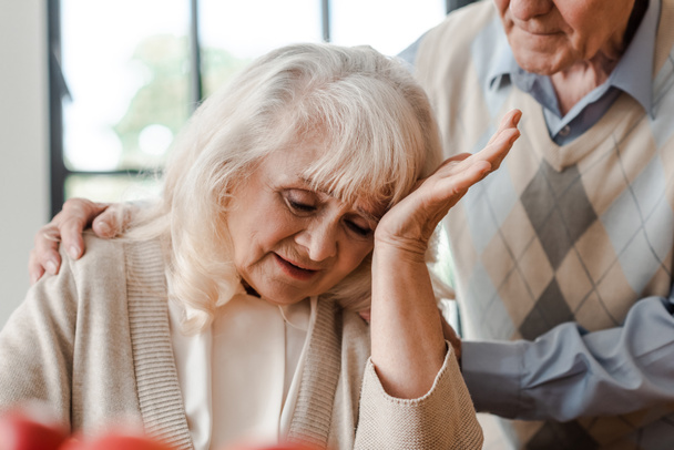 esposa de edad avanzada que tiene dolor de cabeza en casa con el marido durante el aislamiento
 - Foto, Imagen