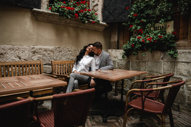 quarantined couple in an empty restaurant,Iloving couple in italian restaurant,a guy with a girl sitting at a table on the street of an Italian restaurant,chairs and tables outside the restaurant,relationship of a young couple - Photo, image