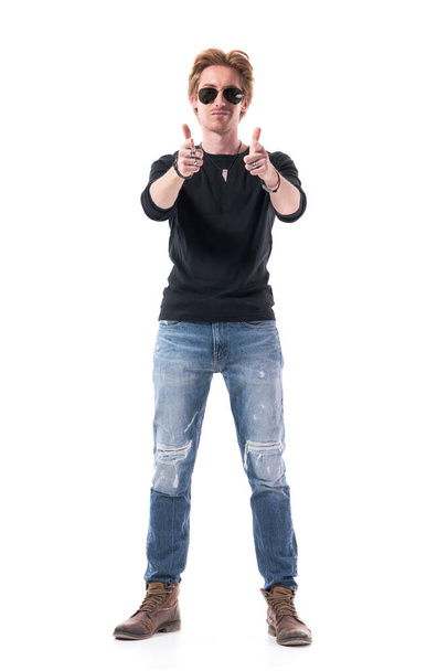 Happy confident stylish man with satisfaction smile pointing finger gun aiming at camera. Full body length isolated on white background.  - Photo, Image