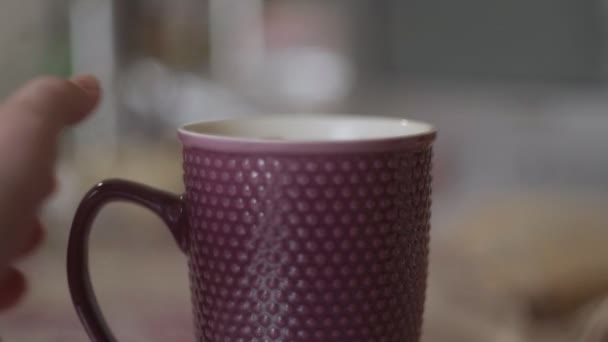 A woman pouring tea from a french press into a mug - Footage, Video