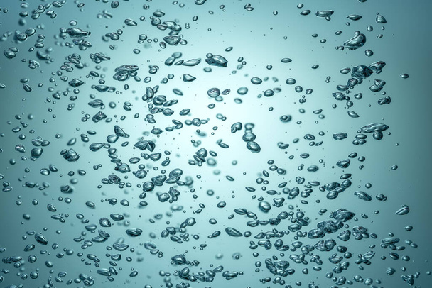 The light breaks through the blue water with bubbles. - Φωτογραφία, εικόνα