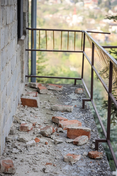 Verspreide en beschadigde bakstenen op het balkon van het huis na een sterke aardbeving van 5,5 op de schaal van Richter een maand geleden in Zagreb, Kroatië - Foto, afbeelding