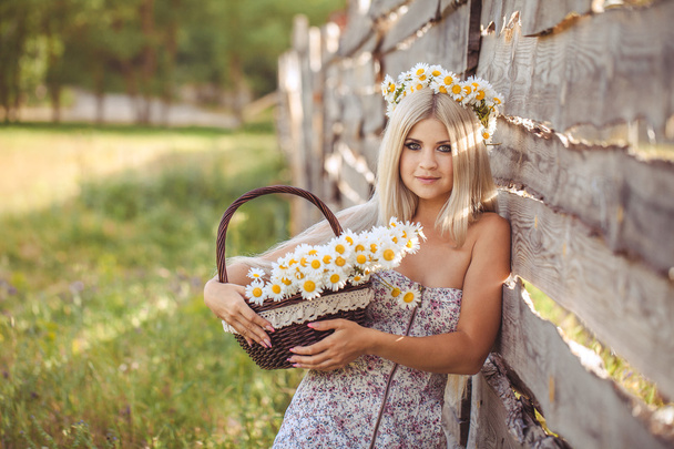Attractive blonde in chamomile field. Young woman in wreath - Φωτογραφία, εικόνα