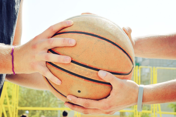 Basketball players holding the ball. Fairplay concept. - Photo, image