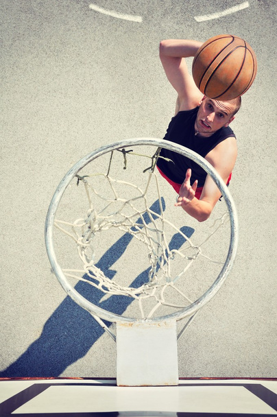 Basketball player in action flying high and scoring - 写真・画像