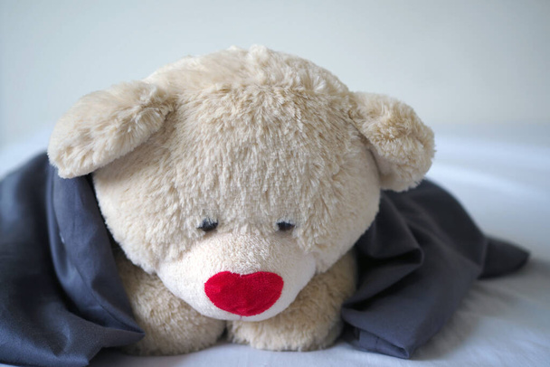 The concept of child sorrow Teddy bear lying alone, sad and disappointed - Photo, Image