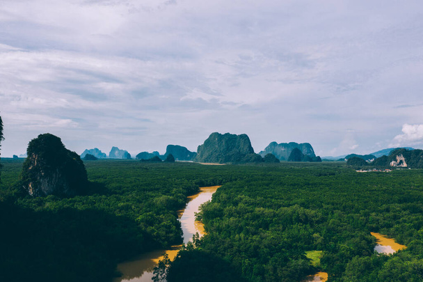 Aerial scenery view of mangroves forest, river canals and mountains. Bird's eye view of beautiful panoramic nature landscape of tropical water jungle on Ao Phang Nga bay National Park, Thailand - Фото, изображение