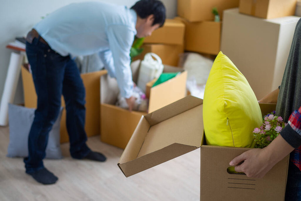 woman is carrying the box for personal items. prepare to move to a new home. - Photo, Image